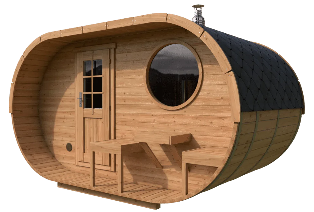 A small, barrel-shaped wooden cabin with a round window, a door with glass panels, and a small porch featuring two built-in benches—perfect as a cosy barrel sauna. The roof has dark shingles and a metal chimney.